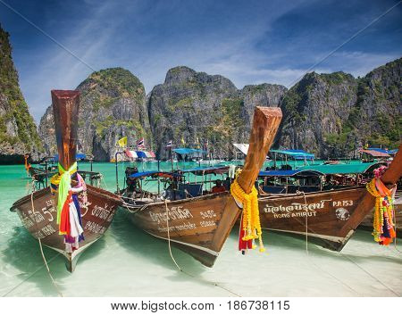 KO PHI PHI LEH, THAILAND, February 1, 2014: Traditional long tail boats on the beach of Maya Bay, Andaman Sea, famous tourist destination in the Ko Phi Phi achipelago