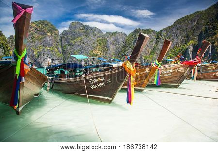 KO PHI PHI LEH, THAILAND, February 1, 2014: Traditional long tail boats on the beach of Maya Bay, Andaman Sea, famous tourist destination in the Ko Phi Phi achipelago