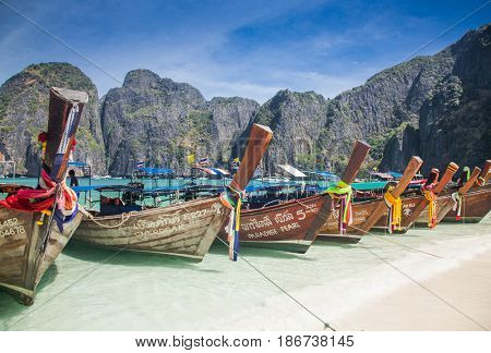 KO PHI PHI LEH, THAILAND, February 1, 2014: Traditional long tail boats on the beach of Maya Bay, Andaman Sea, famous tourist destination in the Ko Phi Phi achipelago
