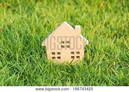 Wooden house on green grass / Eco house