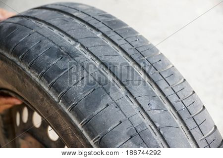 Worn out car tire tread / Danger of using old car tire with low tread depth concept