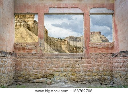 Book Cliffs in eastern Utah as seen through windows of a ruin ghost town building