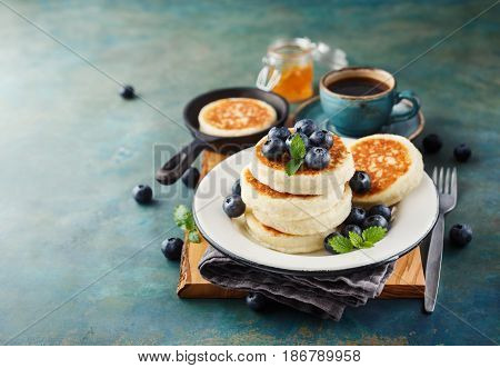 Cottage cheese pancakes with fresh blueberries and coffee Delicious Breakfast