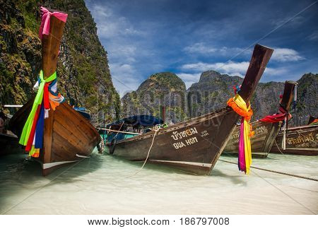 KO PHI PHI LEH, THAILAND, February 1, 2014: Traditional long tail boats on the beach of Maya Bay, Andaman Sea, famous tourist destination in the Ko Phi Phi achipelago