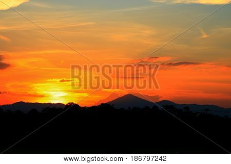 sunset beautiful and silhouette mountain tree woodland colorful landscape in sky twilight time
