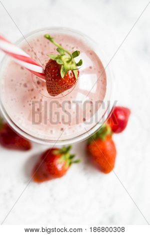 Strawberry-banana smoothie with milk or yoghurt. Healthy summer smoothies to go in a plastic cup