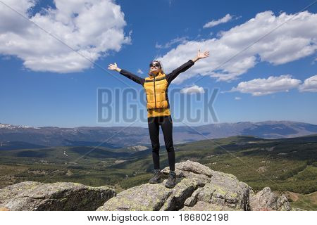 Happy Woman Outstretched Hands On Top Of Mountai