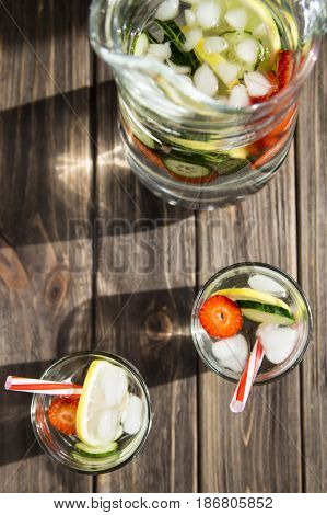 Water with fresh lemon strawberries and cucumber