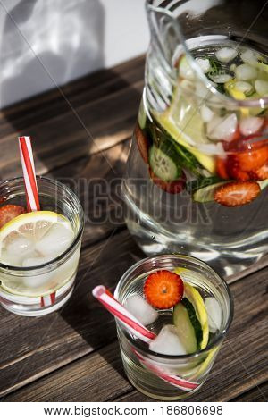 Water withfresh  lemon strawberries and cucumber