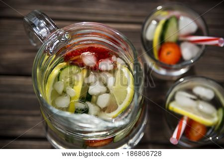 Water withfresh  lemon strawberries and cucumber
