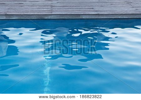 water sport and summer holidays concept - close up of outdoor swimming pool 