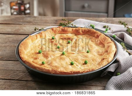 Baked chicken pot pie on wooden table