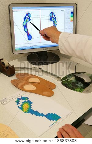 Doctor Preparing Orthopedic Insoles For A Patient