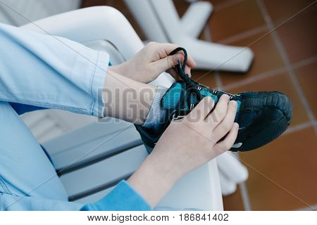 Child tie the laces on his sports shoe
