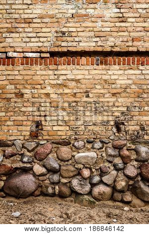 Yellow brick wall background with stone basement