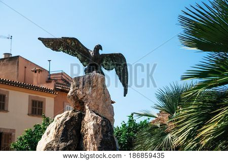 Alcudia Mallorca Spain - May 23 2015: Bronze statue of an eagle which was the symbol of the Roman legions in Carles V square area in Alcudia. Mallorca Spain