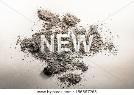Word new written in grey ash dust dirt as a irony oxymoron paradox concept for old news business sale death life future advertisement background