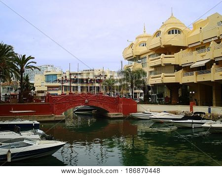 Puerto Marina is а real mini-city with houses on artificial islands. Apartments in such houses cost very much. It is possible to reach these houses either by the boat or sometimes by bridge. On the photo the red bridge to one of houses and boats at moorin