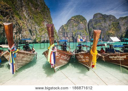 KO PHI PHI LEH, THAILAND, February 1, 2014: Traditional long tail boats on the beach of Maya Bay, Andaman Sea, famous tourist destination in the Ko Phi Phi achipelago