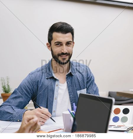 Young man preparing a new decoration project in a coworking espace