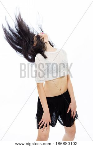 Young Asian teenage girl flinging hair back