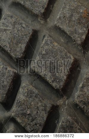 Tire tread pattern of roadroller/ The black tyre of roadroller.