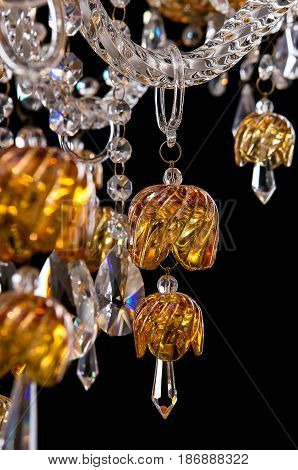 Contemporary gold chandelier isolated on black background. close-up . Crystal chandelier.