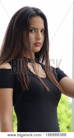 Serious Female Teen Wearing a Black Dress