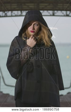 Young girl posing on pier at Lake Siutghiol