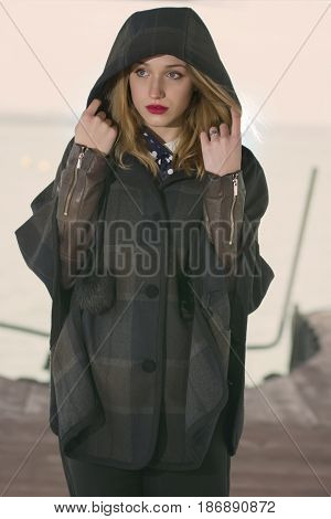 Young girl posing on pier at Lake Siutghiol