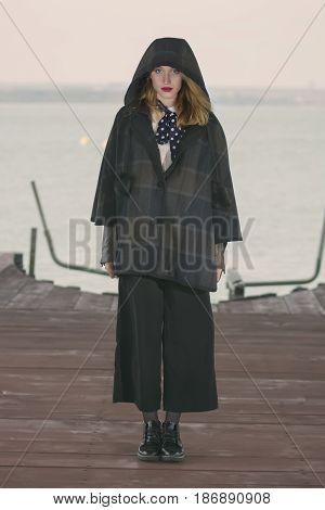 Young girl posing on pier at Lake Siutghiol