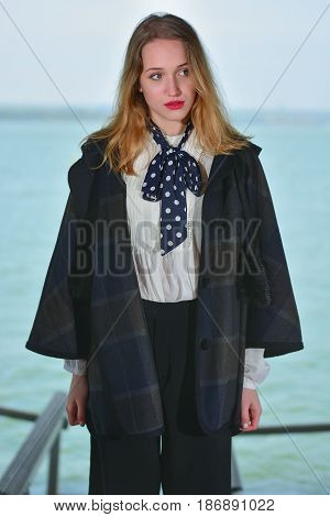 Young girl posing on pier at Lake Siutghiol