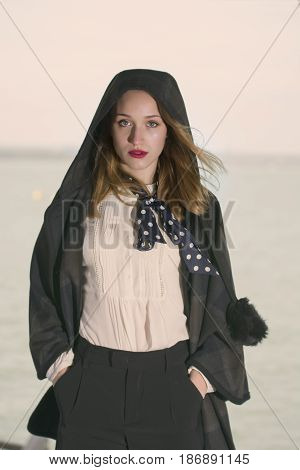 Young girl posing on pier at Lake Siutghiol