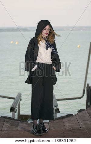 Young girl posing on pier at Lake Siutghiol