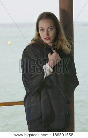 Young girl posing on pier at Lake Siutghiol