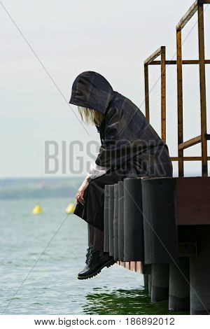 Young girl posing on pier at Lake Siutghiol