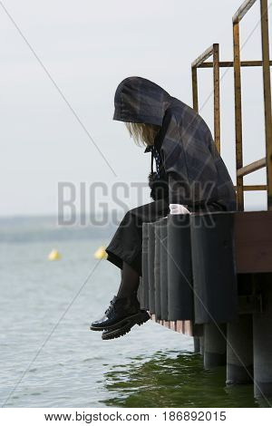 Young girl posing on pier at Lake Siutghiol