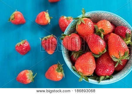close view of somefresh strawberries in a bowl isolated on a background