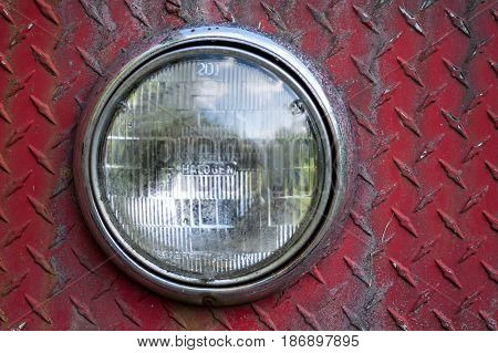 Headlights on rusted and weathered diamond plate sheet metal