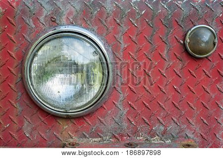 Headlights on rusted and weathered diamond plate sheet metal