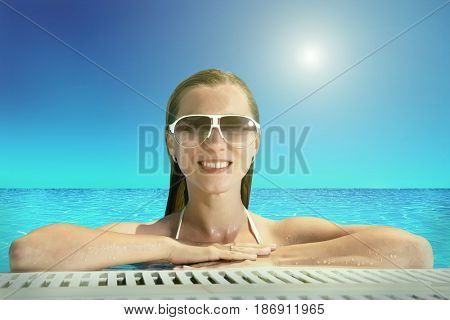 Beautiful happiness girl in white bikini stay in the waterpool