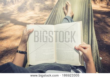 Women sleeping reading. In the hammock. In the natural atmosphere in the park