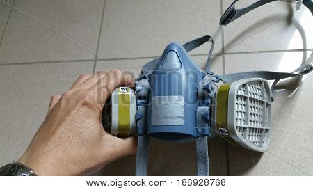 Multi-purpose respirator half mask for toxic gas protection. Officer prepare to use Multi-purpose respirator half mask.