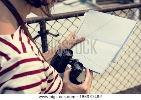 Woman traveler with binocular wanderlust