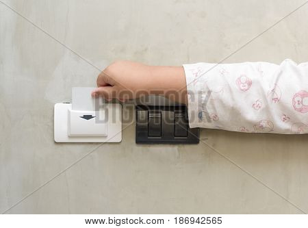 child putting key card switch in hotel room