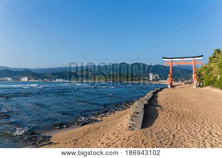 Red torii in Aoshima Shrine with blue sky