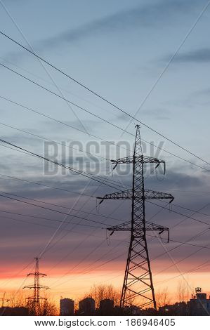 High-voltage Electric Main Against The Dark Blue Sky