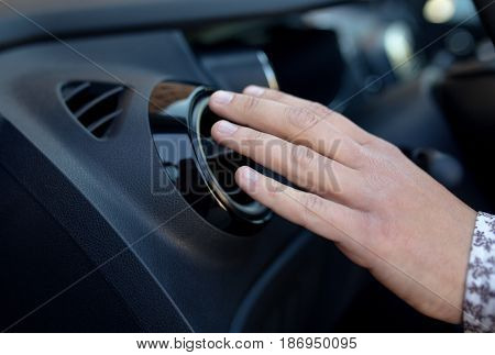 Driver hand on air ventilation grille with power regulator checking the air from air ventilation in the car