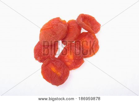 Delicious dried organic apricots isolated over white background