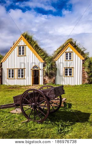 The village of old houses covered with turf and rural cart. Ethnographic Museum-estate Glaumbaer, Iceland. The concept of the historical and cultural tourism